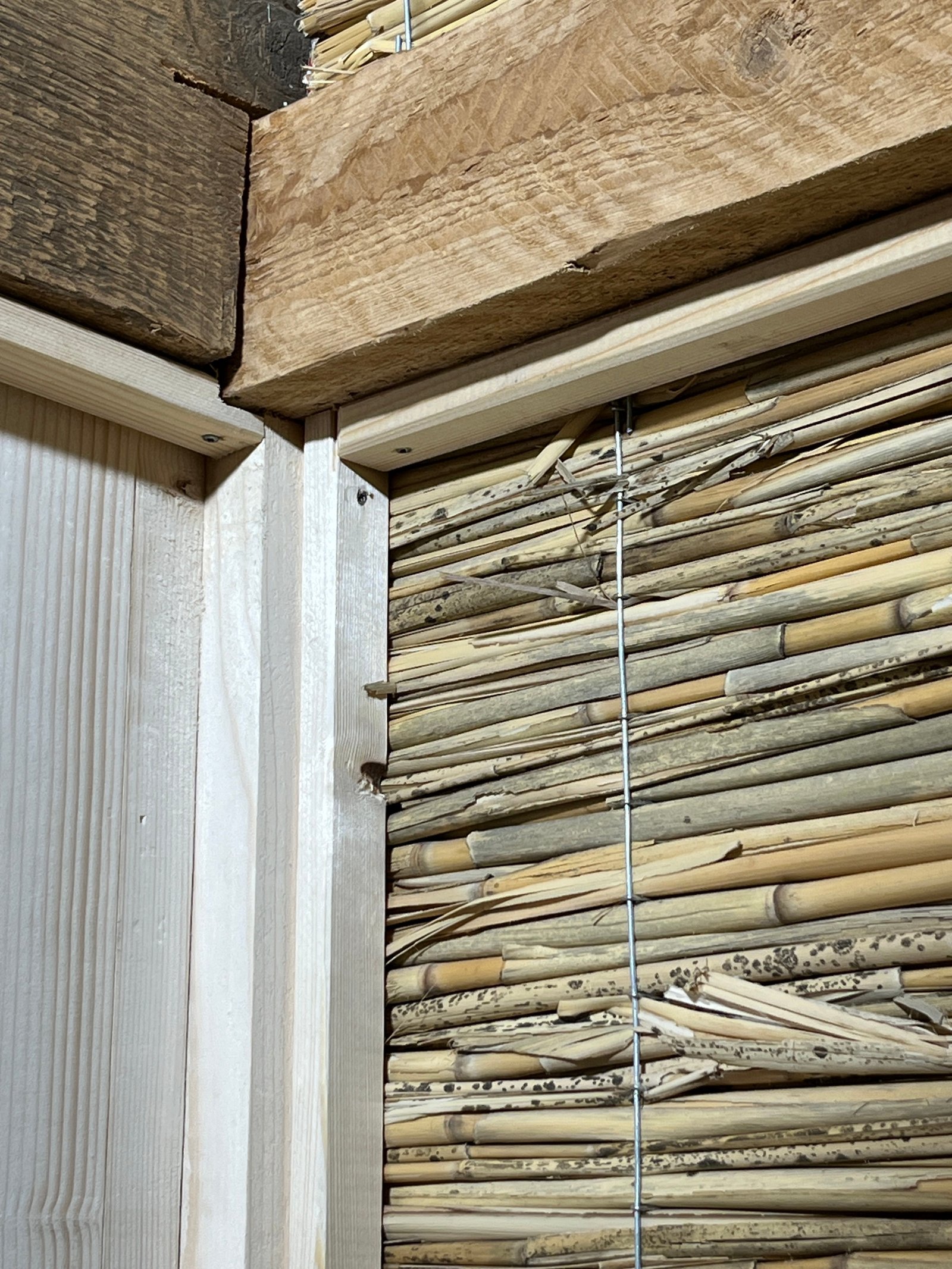 Gartenhaus-Innendetail: Holzdielenboden und Lehmputzwand im Übergang, Qualität